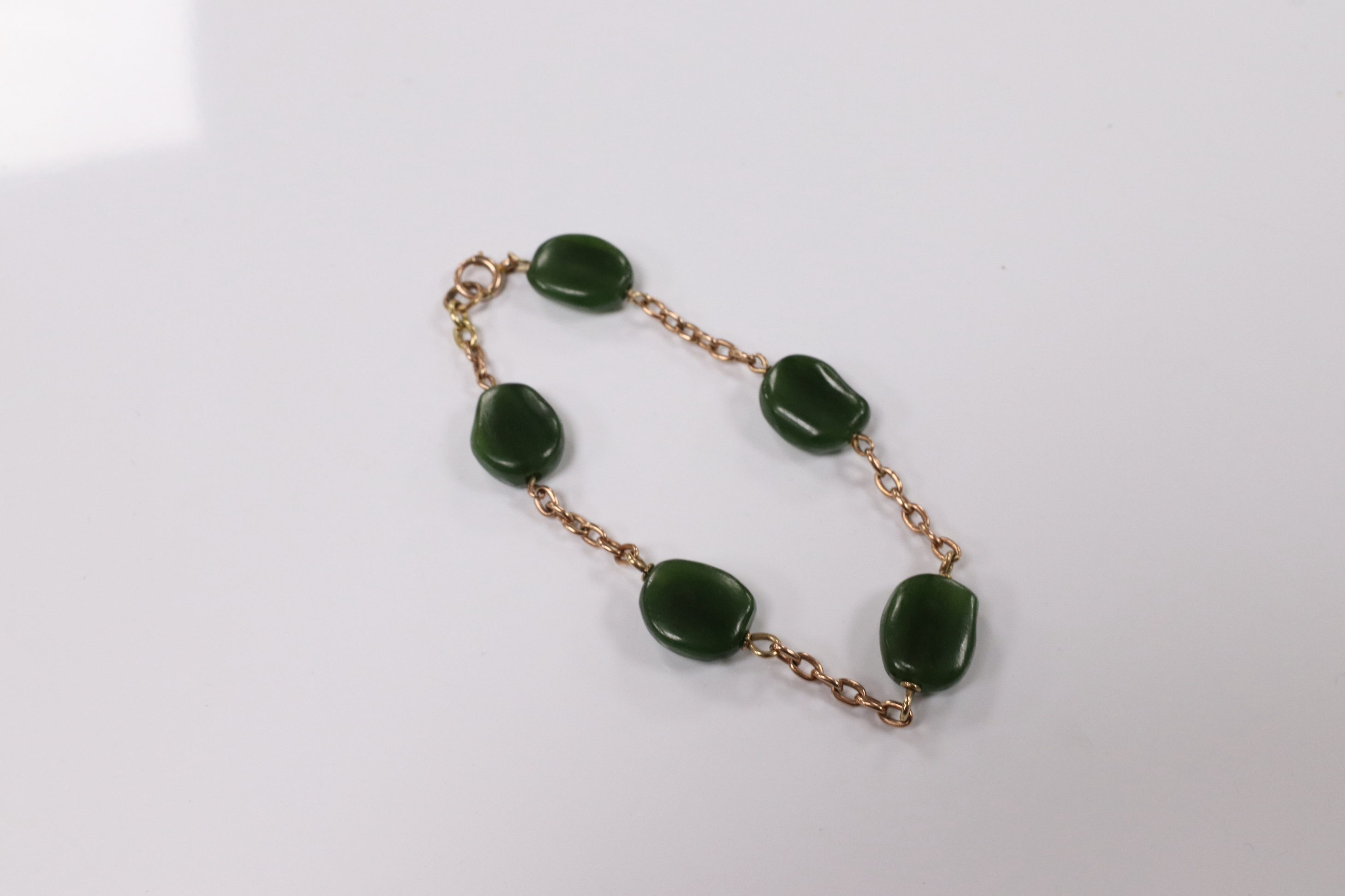 A 9ct and five stone jade bead set bracelet, 19cm, gross weight 15.2 grams. Condition - fair